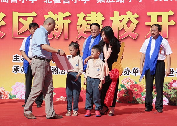河北宇辰地产开发公司副总经理靳勇为瀚唐和雅小学颁发金钥匙并赠送价值三万元学习用品