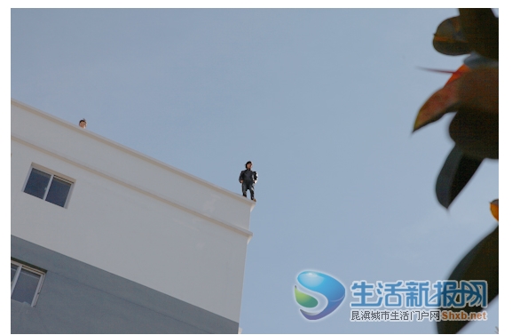 2月3日,"讨薪民工"站在6楼楼顶,声称要跳楼